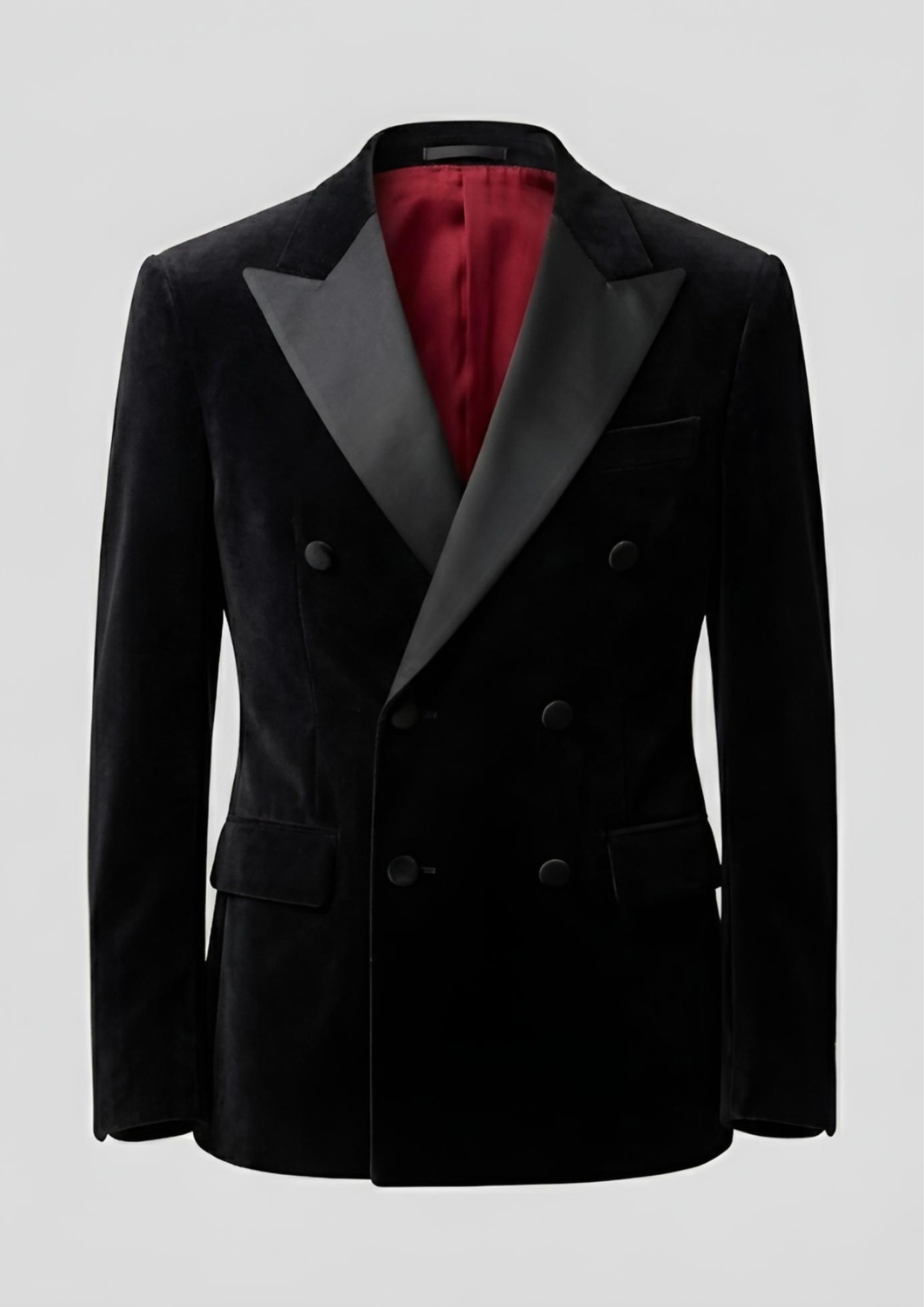 "Man wearing a black double breasted velvet tuxedo jacket with peak lapels."