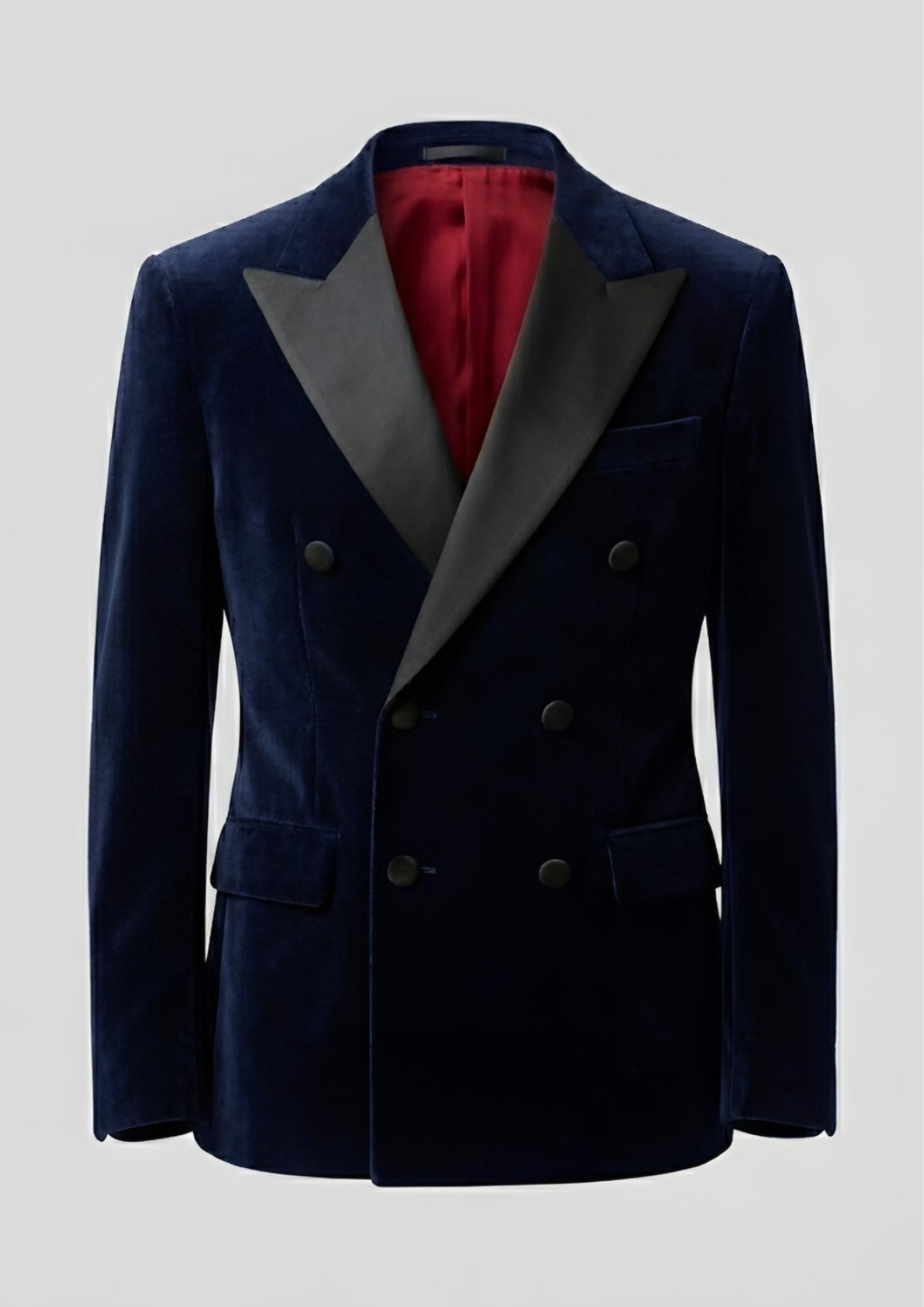 "Man wearing a navy blue double breasted velvet tuxedo jacket with peak lapels."