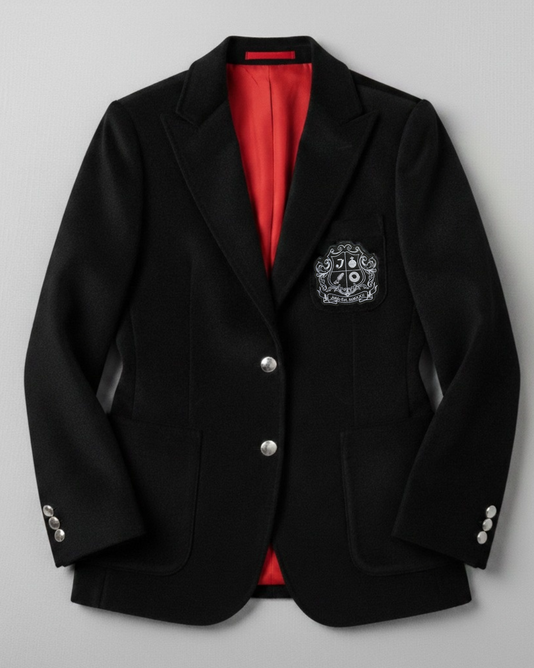Black velvet women's blazer with silver buttons and embroidered crest.