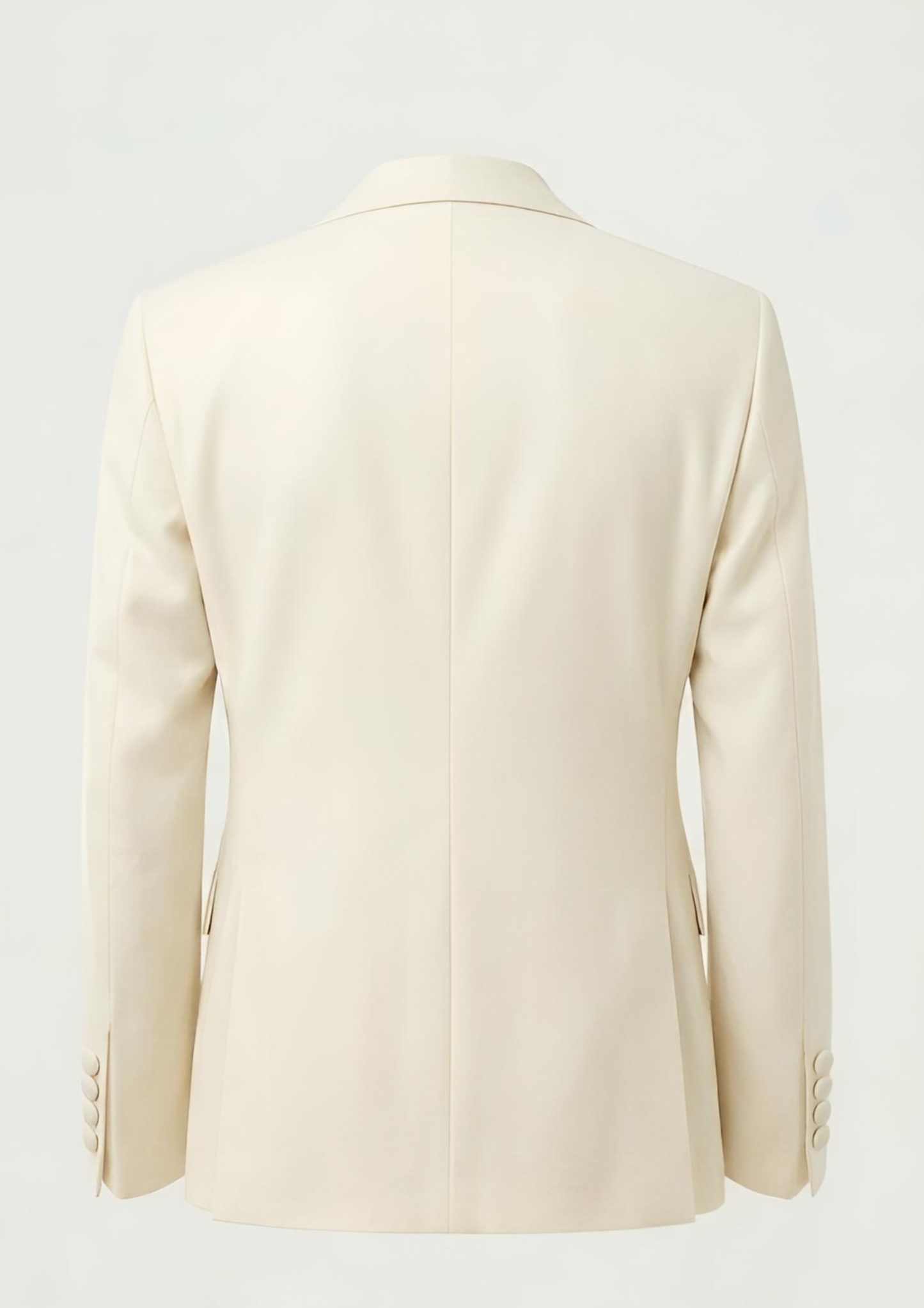 "Man wearing an ivory double breasted velvet tuxedo jacket with peak lapels."